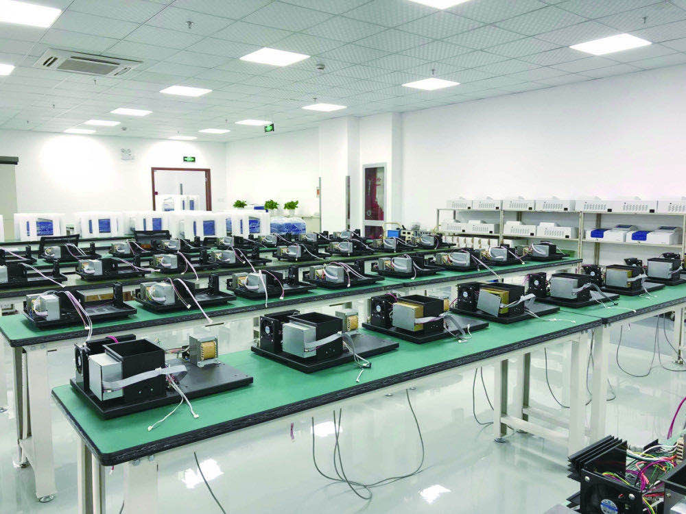 Assembly line for manufacturing UV-Vis spectrophotometers in a laboratory instrument production facility.