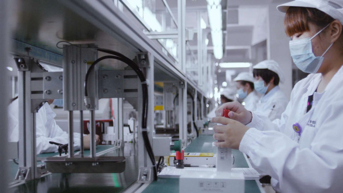 Workers manufacturing medical zirconia ceramic components in cleanroom